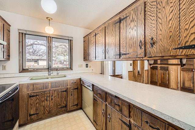 kitchen with light floors, dishwasher, light countertops, electric range oven, and a sink