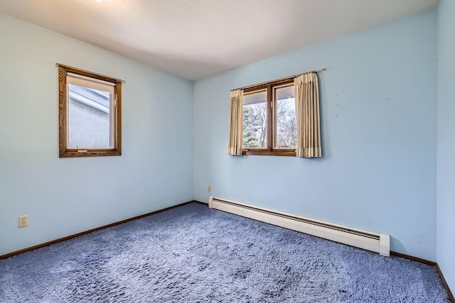 unfurnished room featuring baseboards, carpet, and a baseboard radiator