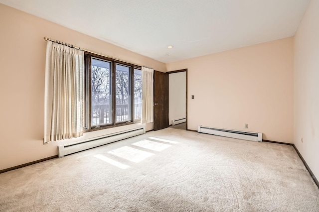 unfurnished room with a baseboard radiator and carpet