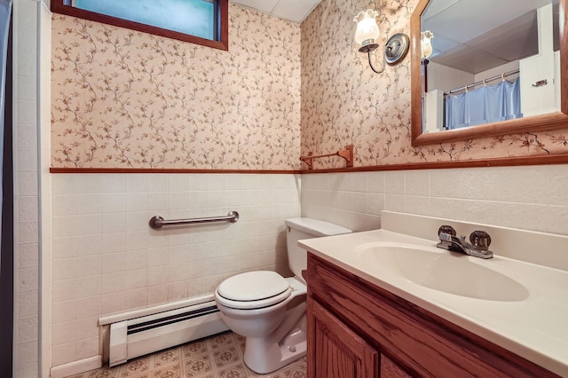 full bath with vanity, a baseboard radiator, wallpapered walls, wainscoting, and toilet