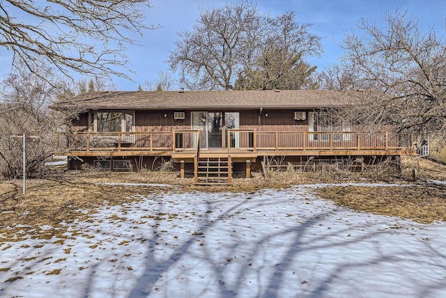 view of front facade featuring a wooden deck and a shingled roof