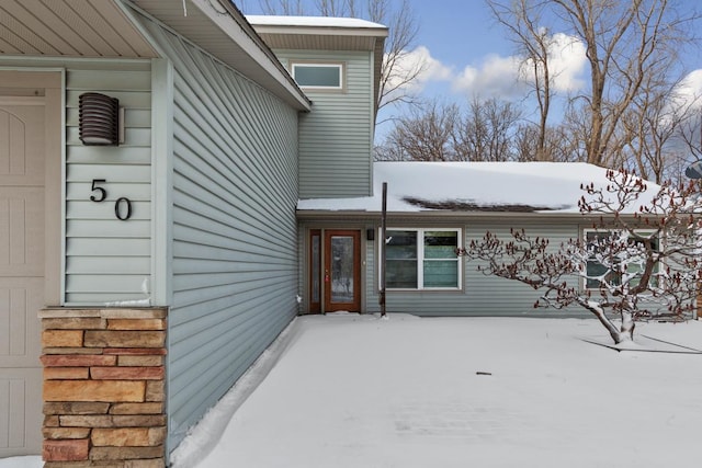 view of snow covered property entrance