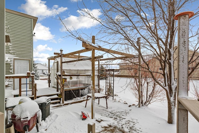 snow covered deck featuring an exterior structure and an outbuilding