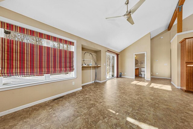 spare room featuring a ceiling fan, visible vents, vaulted ceiling, and baseboards