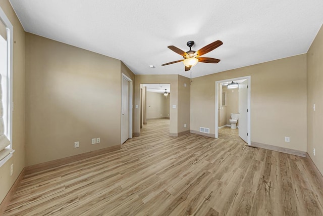 unfurnished bedroom with light wood-type flooring, visible vents, and baseboards