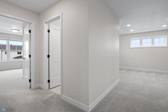 corridor featuring baseboards, carpet flooring, and recessed lighting