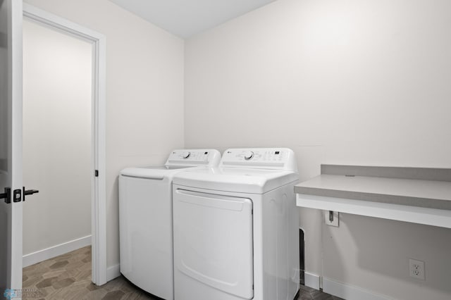 clothes washing area featuring laundry area, independent washer and dryer, tile patterned floors, and baseboards