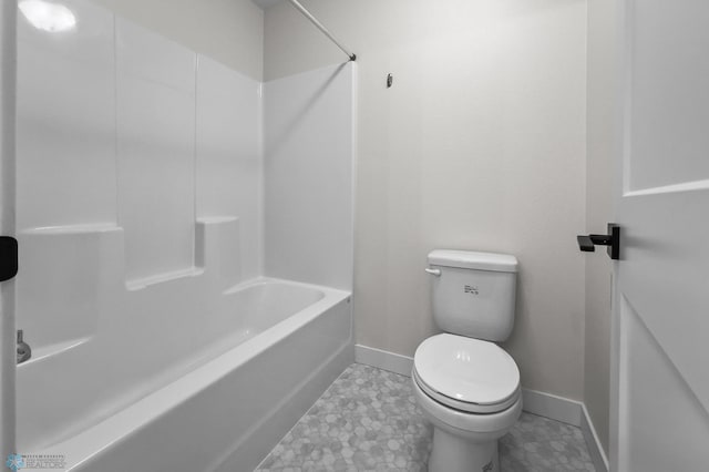 full bath featuring toilet, baseboards, and  shower combination