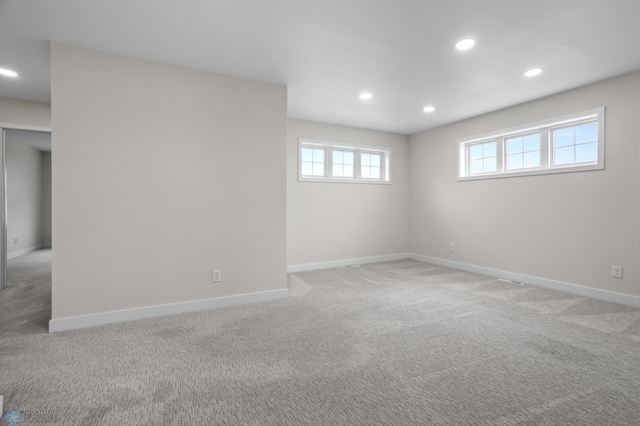 basement with light carpet, baseboards, and recessed lighting