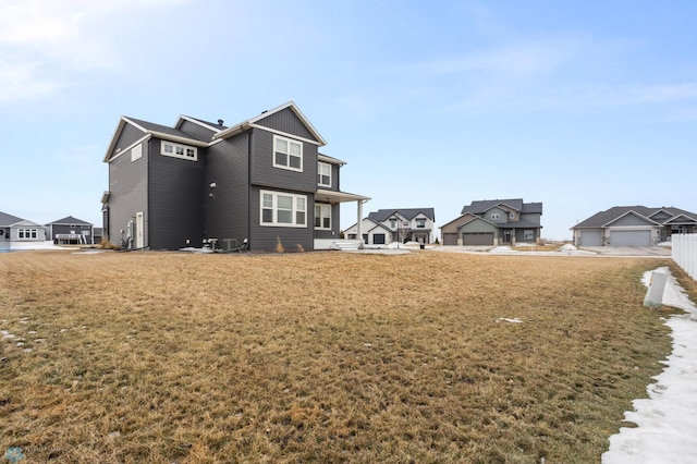 rear view of house featuring a lawn