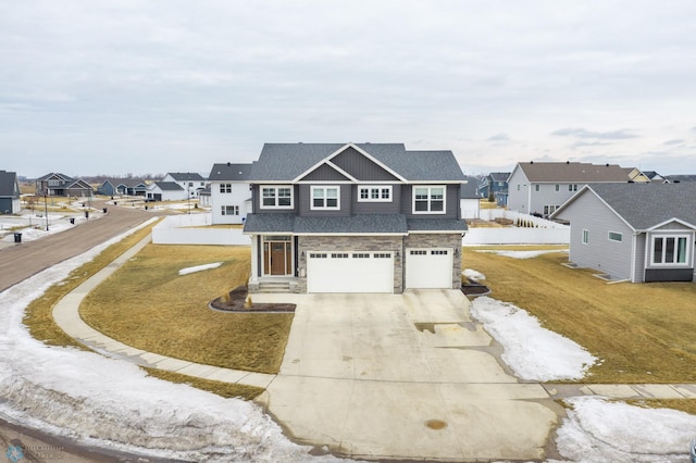 traditional home with a garage, concrete driveway, stone siding, roof with shingles, and a residential view