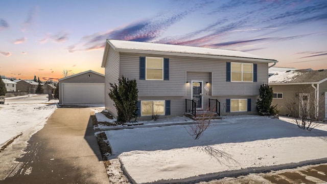 split foyer home with an outdoor structure and a detached garage