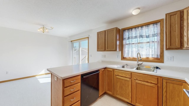 kitchen with a peninsula, a sink, light countertops, dishwasher, and brown cabinets