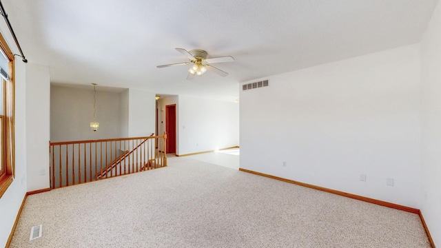 carpeted empty room with visible vents and baseboards