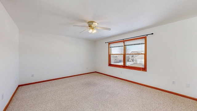 spare room with light carpet, visible vents, and baseboards