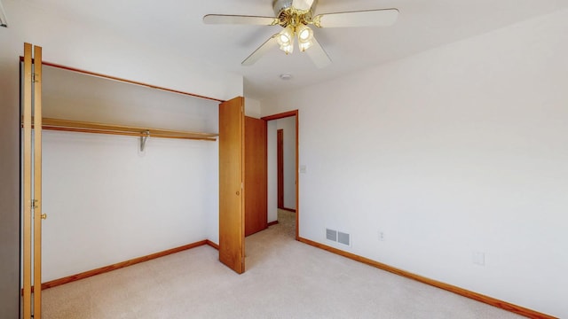 unfurnished bedroom featuring visible vents, light carpet, baseboards, and a closet