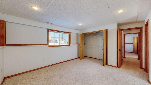 unfurnished bedroom with recessed lighting, carpet, baseboards, and a closet