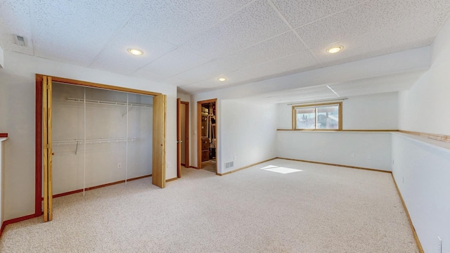 unfurnished bedroom featuring a closet, recessed lighting, baseboards, and carpet floors