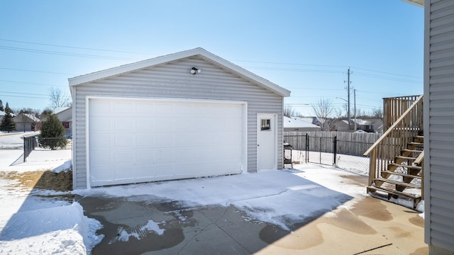 detached garage featuring fence