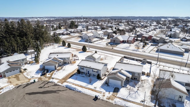 snowy aerial view with a residential view