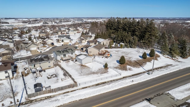 snowy aerial view with a residential view