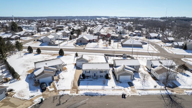 snowy aerial view with a residential view