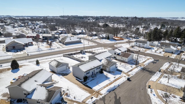 snowy aerial view with a residential view