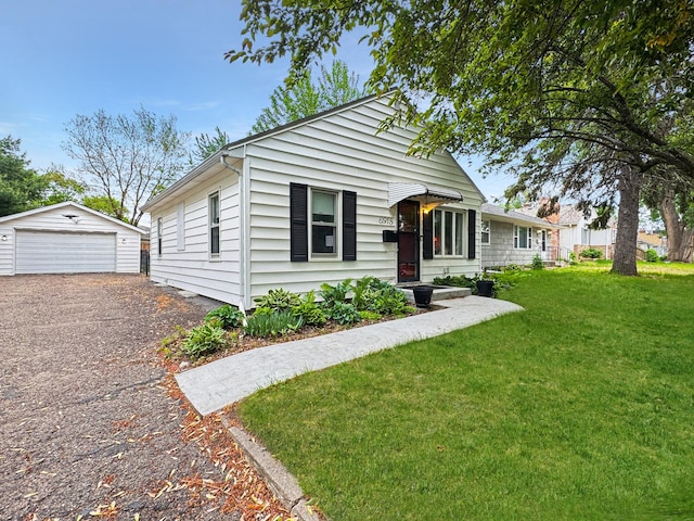 6915 11th Ave S, Richfield, MN 55423 - view of front of home featuring a detached garage, an outdoor structure, and a front lawn