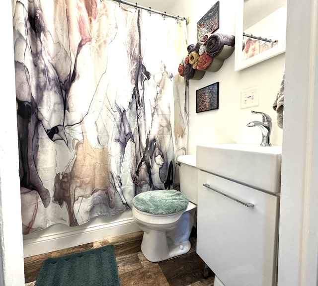 6915 11th Ave S, Richfield, MN 55423 - bathroom featuring vanity, toilet, wood finished floors, and curtained shower