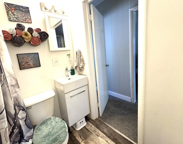 6915 11th Ave S, Richfield, MN 55423 - bathroom featuring wood finished floors, vanity, and toilet