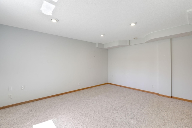 unfurnished room with baseboards, recessed lighting, and light colored carpet