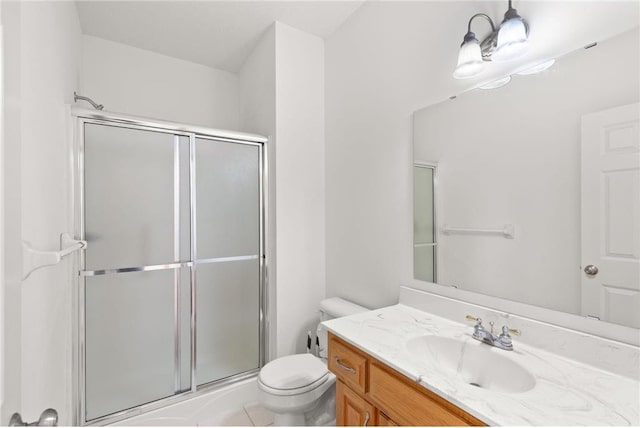 bathroom featuring a stall shower, vanity, and toilet