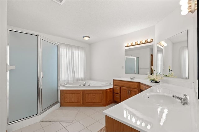 full bathroom with a garden tub, double vanity, a sink, a shower stall, and a textured ceiling