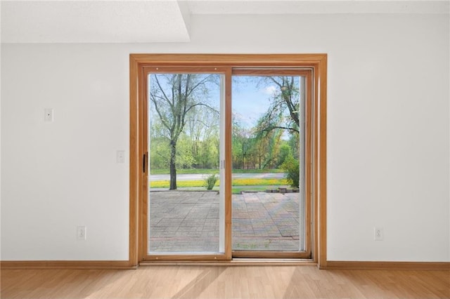 entryway with light wood finished floors and baseboards