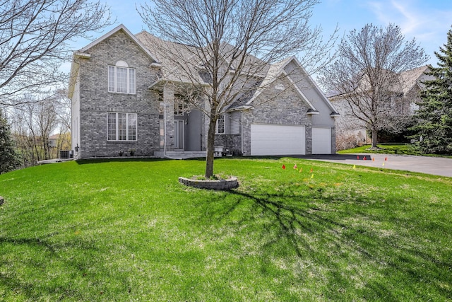 traditional-style home with central AC unit, a garage, brick siding, driveway, and a front yard