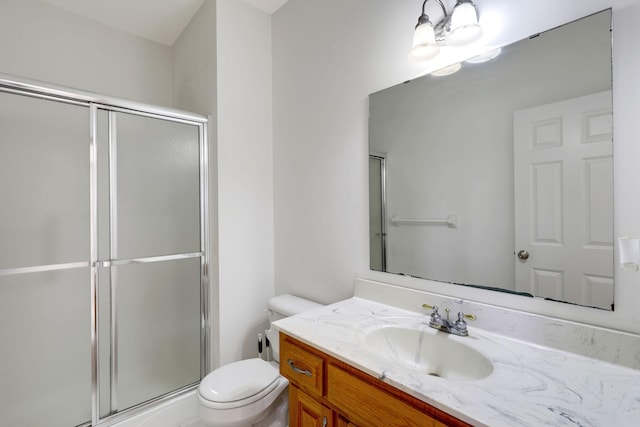 full bathroom with vanity, toilet, and a shower stall