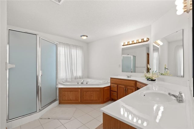 bathroom with a sink, tile patterned floors, a shower stall, double vanity, and a bath