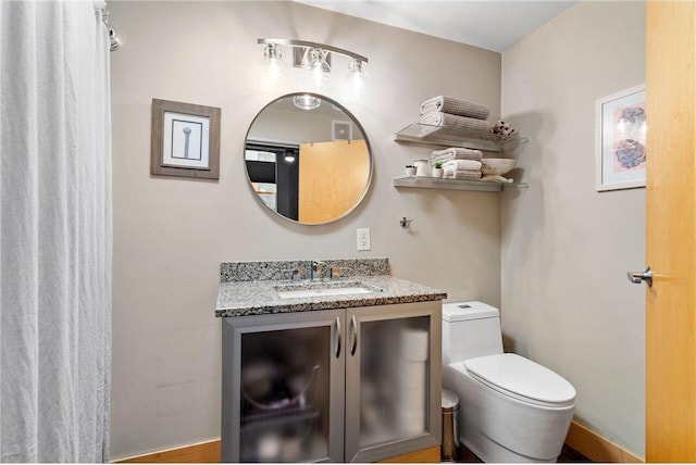 bathroom with toilet and vanity