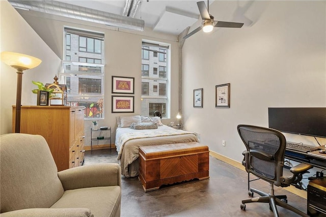 bedroom with baseboards and concrete flooring