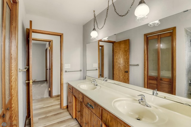3129 7th St N, Fargo, ND 58102 - full bath featuring wood finished floors, double vanity, and baseboards