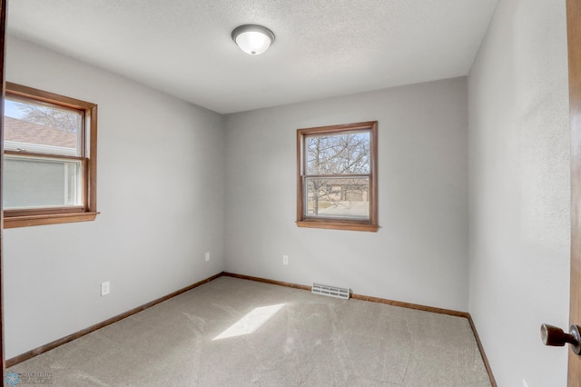 3129 7th St N, Fargo, ND 58102 - carpeted spare room with baseboards and a textured ceiling
