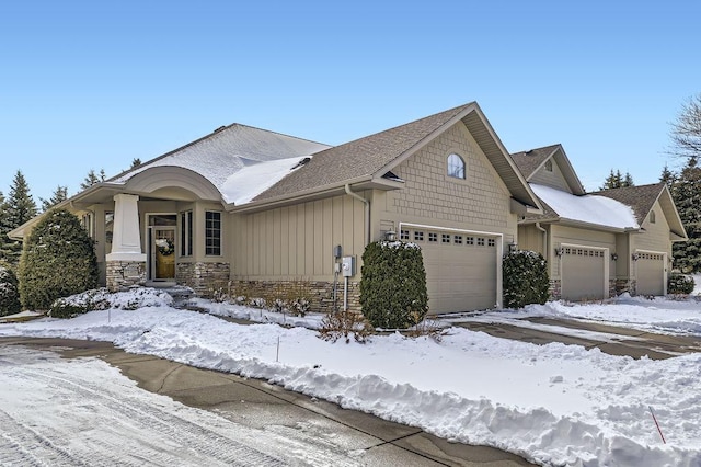 view of front of home featuring a garage and stone siding