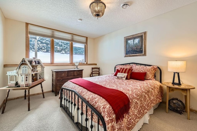 carpeted bedroom with a textured ceiling and baseboards