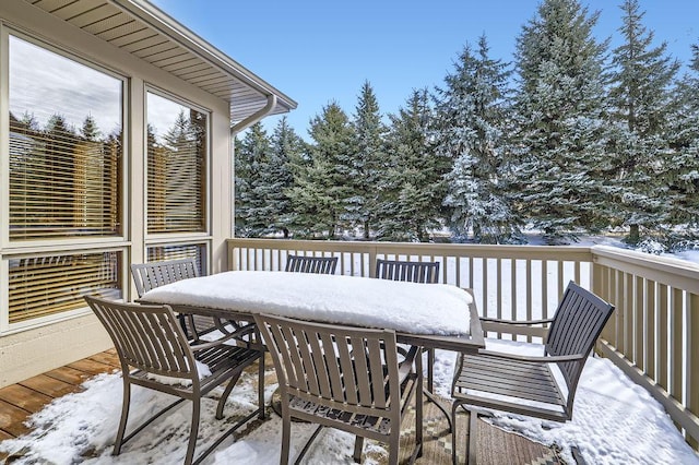 snow covered deck featuring outdoor dining space