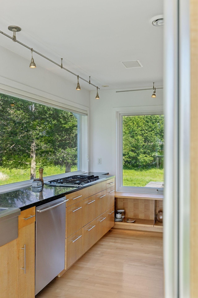 2049 Broadway St, Marine On Saint Croix, MN 55047 - kitchen featuring appliances with stainless steel finishes, light wood-style floors, modern cabinets, and dark stone counters