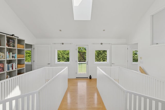 2049 Broadway St, Marine On Saint Croix, MN 55047 - hallway featuring vaulted ceiling, light wood-style floors, a skylight, and an upstairs landing