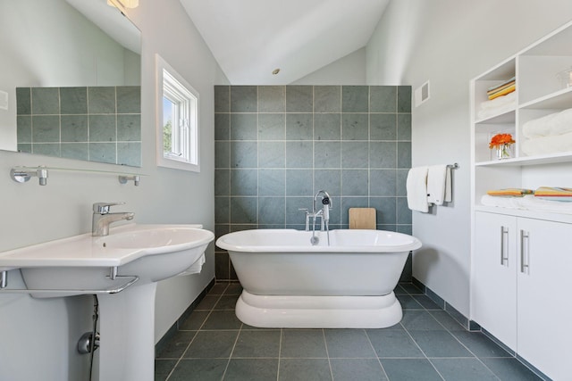2049 Broadway St, Marine On Saint Croix, MN 55047 - bathroom with a soaking tub, lofted ceiling, tile patterned floors, and tile walls