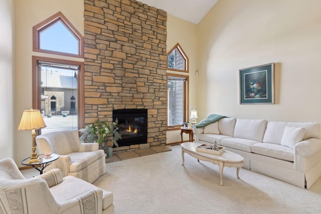 living room with high vaulted ceiling, carpet, and a stone fireplace