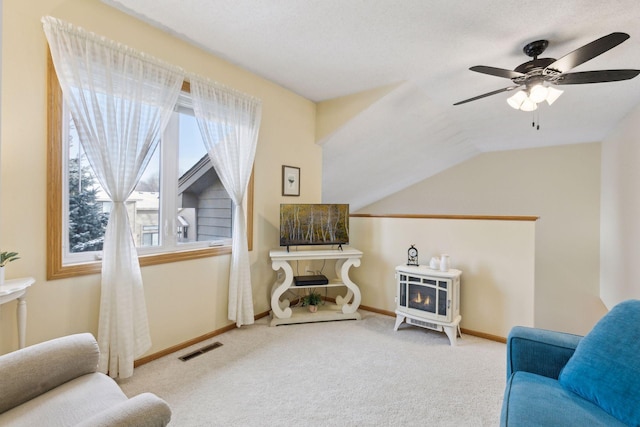 sitting room featuring carpet, visible vents, lofted ceiling, and baseboards