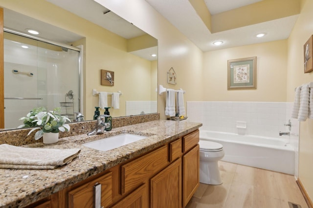 full bathroom featuring a garden tub, recessed lighting, toilet, a shower stall, and vanity